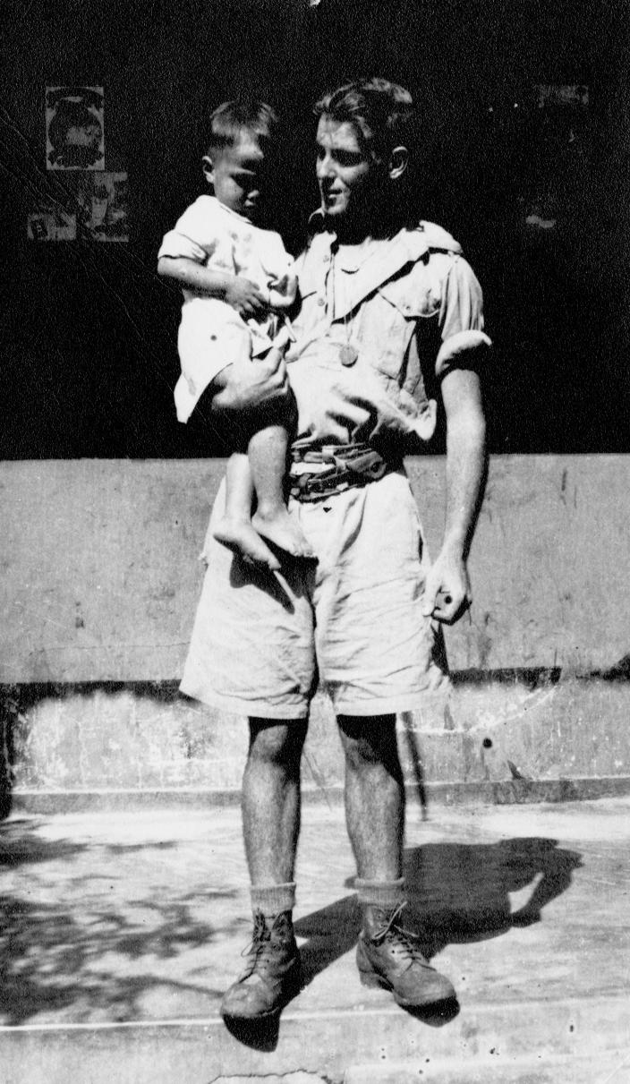 Pte Albert ‘Alby’ Friend holding a child at Bazaar Tete in March 1942